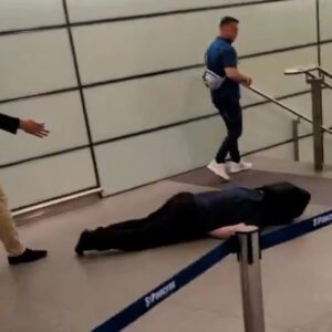 Tommy Robinson walks away from unconscious man after an altercation at St Pancras station